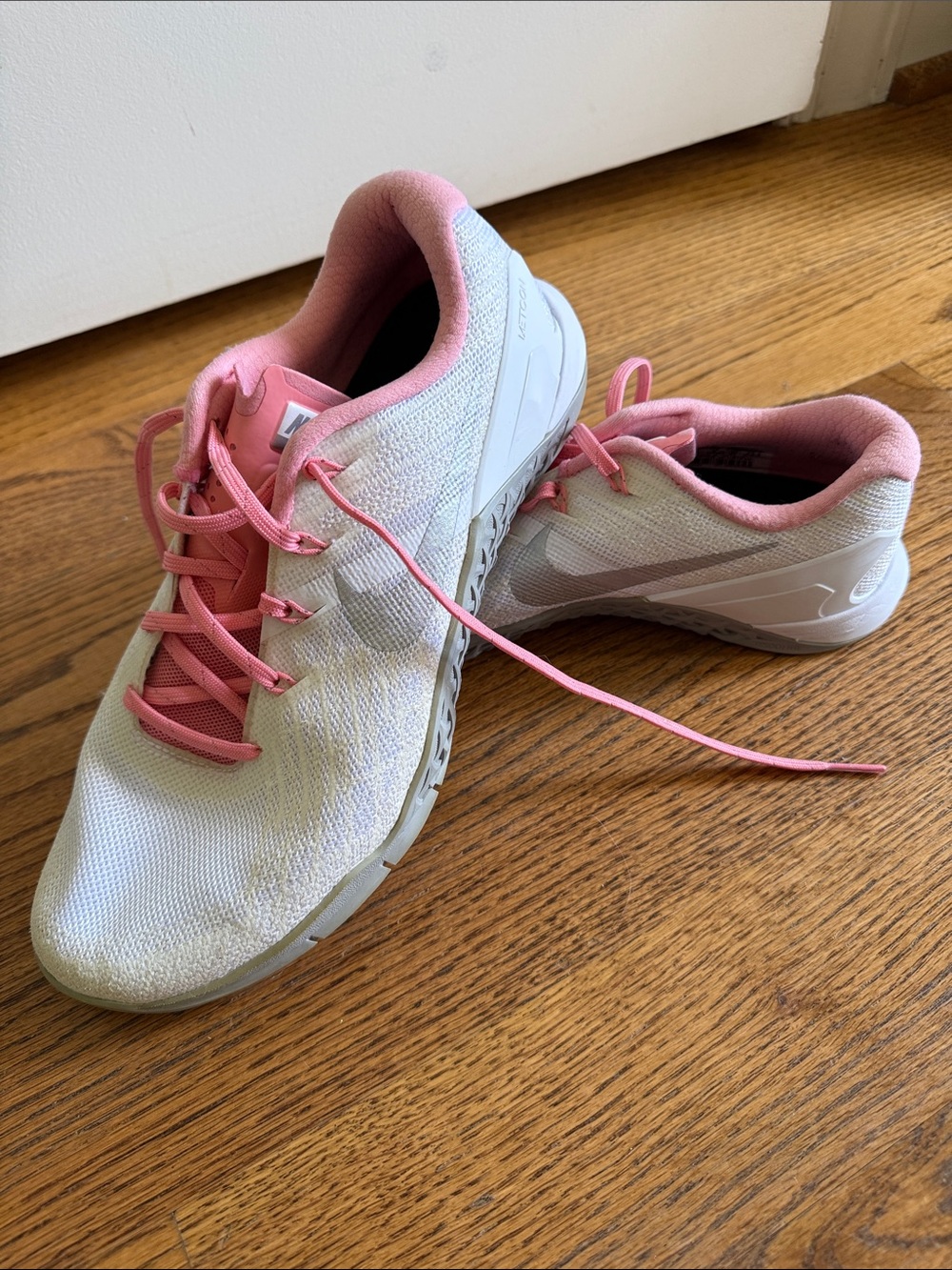 Women’s white and pink Nike Metcons